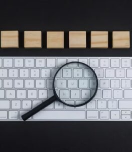 conceptual-research-with-keyboard-magnifier-wooden-cubes-black-desk-background-flat-lay-horizontal-image_176474-6277